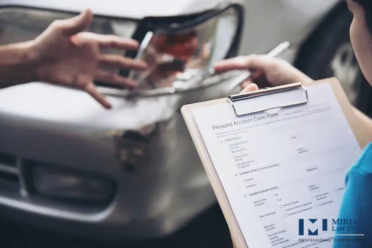 A person holds a "Personal Accident Claim Form", pointing to damage on a car's headlight after a collision.