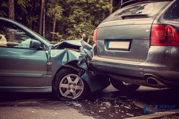 Rear-end car collision showing a blue car severely damaged into a grey SUV.
